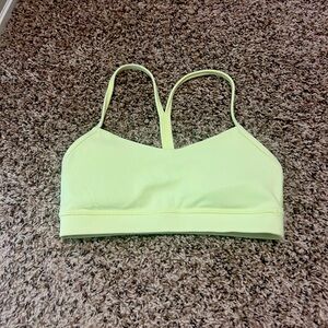 Lululemon light support sport bra in a greenish yellow color.
